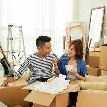 Couple moving into their new home taking a break from unpacking boxes